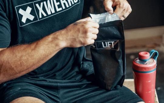 Bag of XWERKS creatine being opened by a man