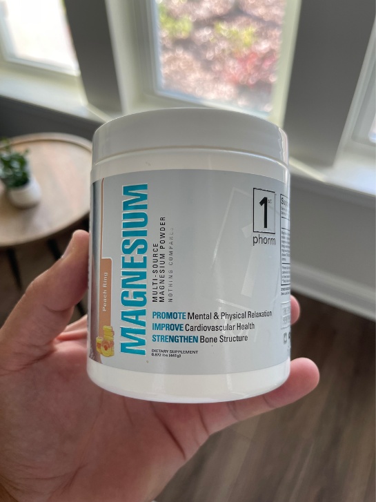 1st phorm magnesium supplement being held by someone