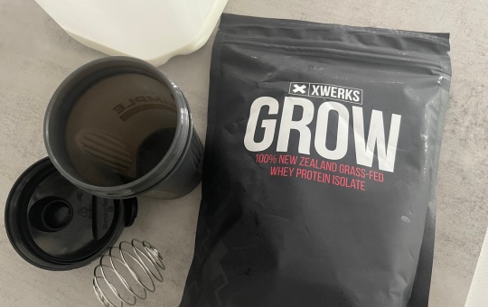 Shaker bottle for protein next to XWERKS Grow