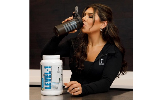 1st phorm level-1 protein powder with a woman drinking out of a shaker bottle