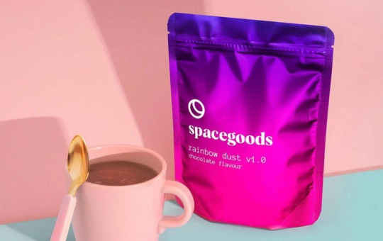 pink mug and spoon next to a bag of spacegoods rainbow dust