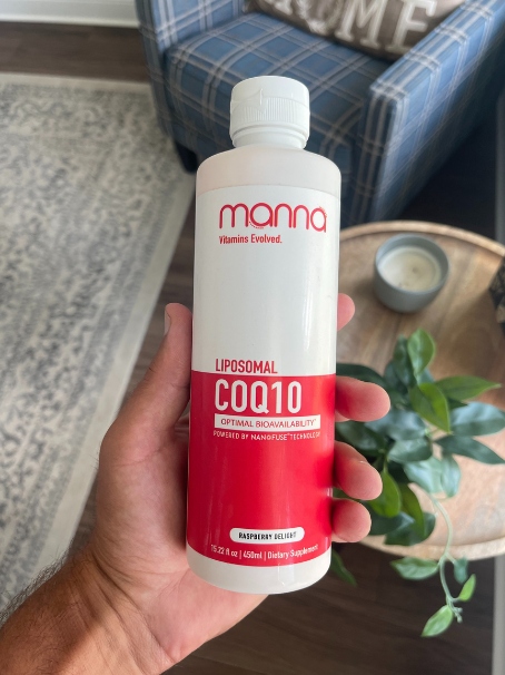 holding the manna CoQ10 bottle